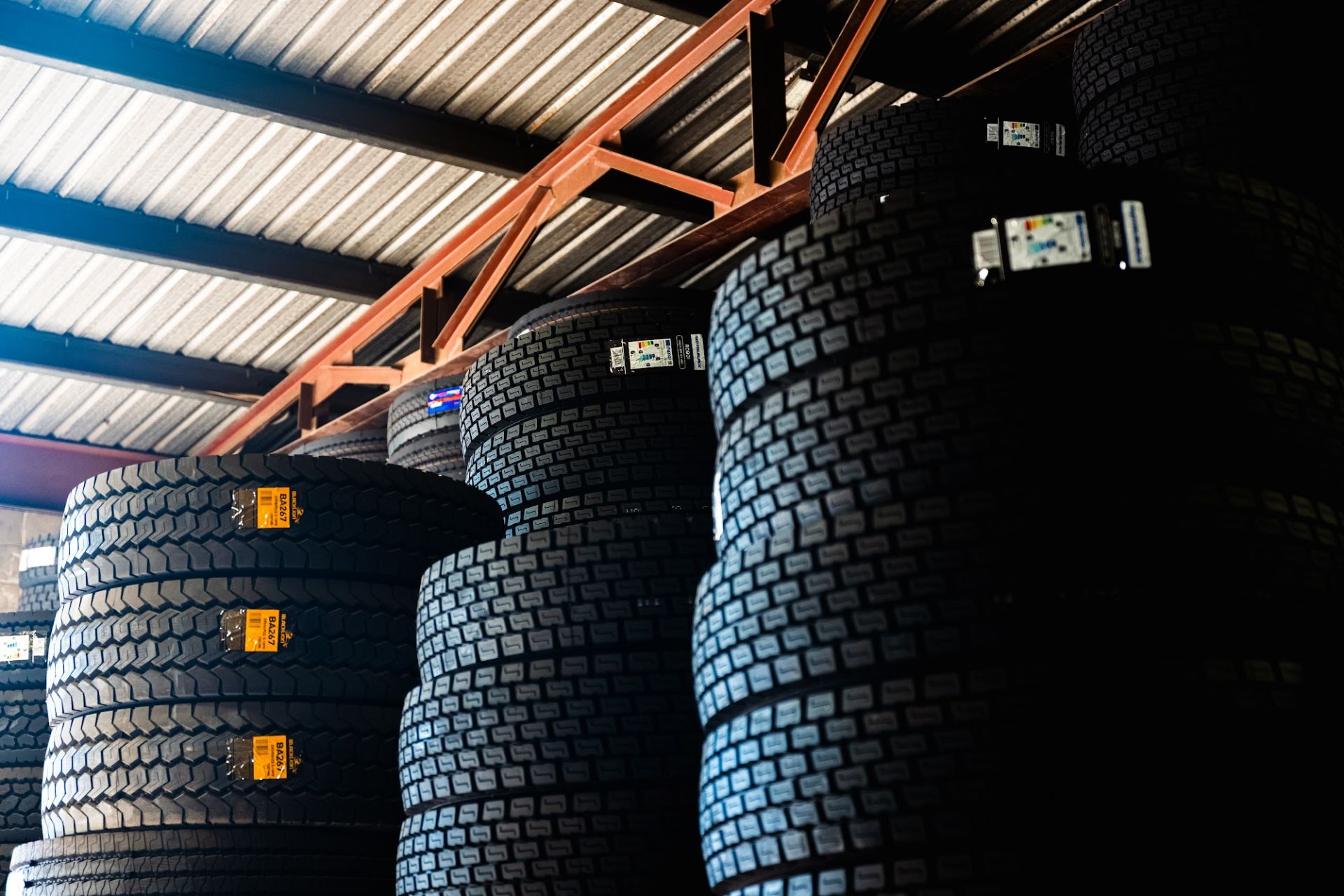 Truck tyres stacked in the Infinity Tyres warehouse